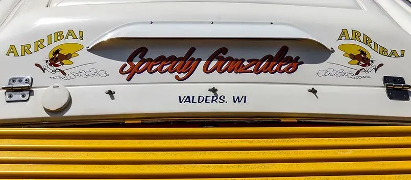 The back of a white vehicle with the words speedy gonzales on it