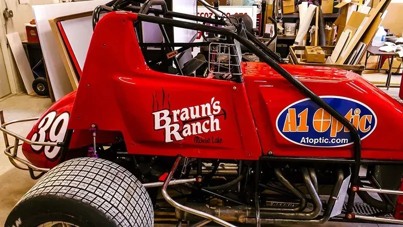 A red race car with braun 's ranch written on the side