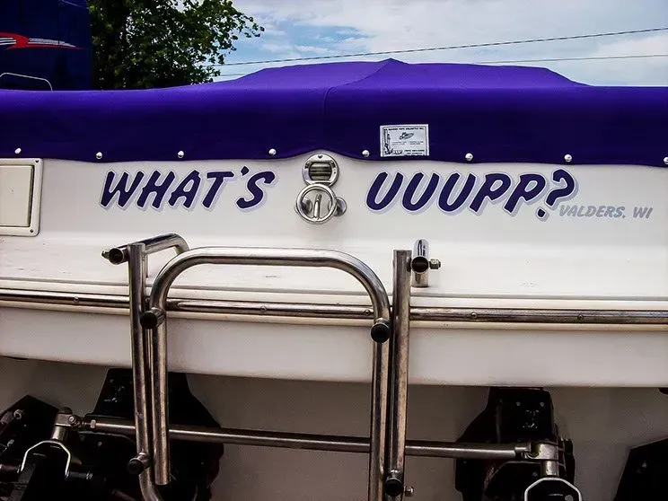 A boat with the words what 's uuupp written on it