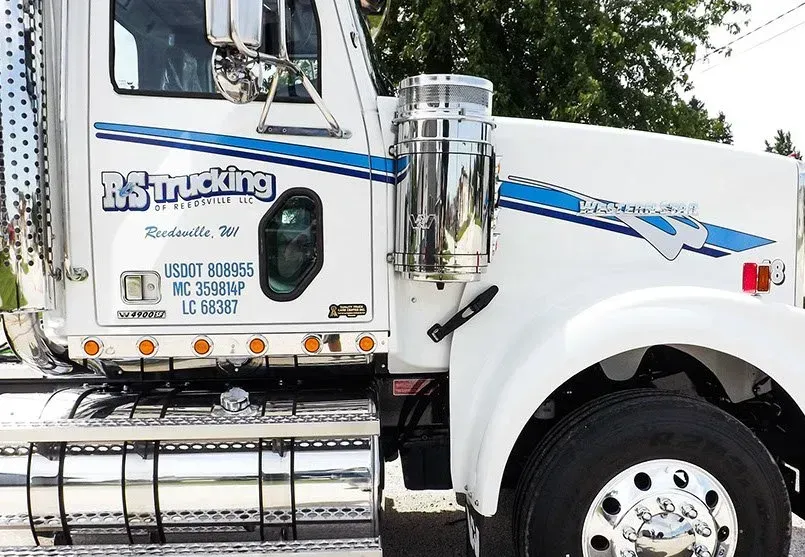 A white truck is parked on the side of the road.
