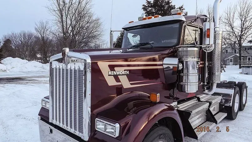 A kenworth semi truck is parked in the snow