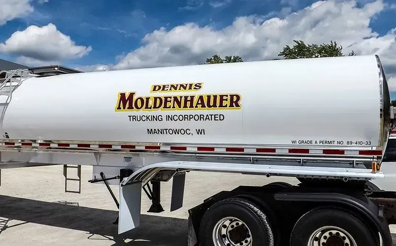 A dennis moldenhauer truck is parked in a parking lot