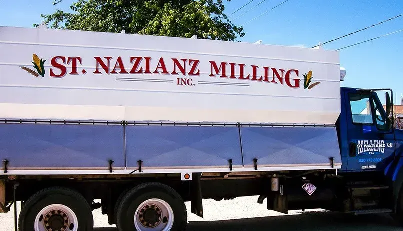 A st. nazianz milling truck is parked on the side of the road