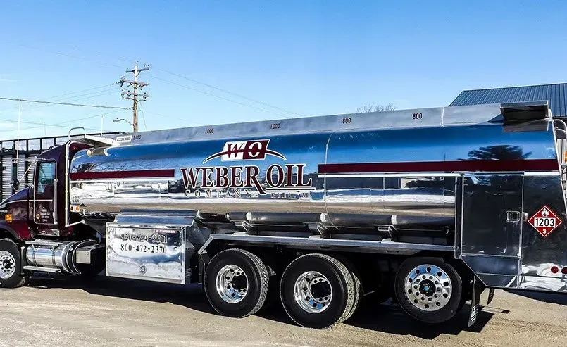 A large tanker truck is parked on the side of the road.