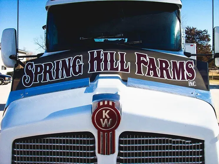 A white truck with spring hill farms written on the front
