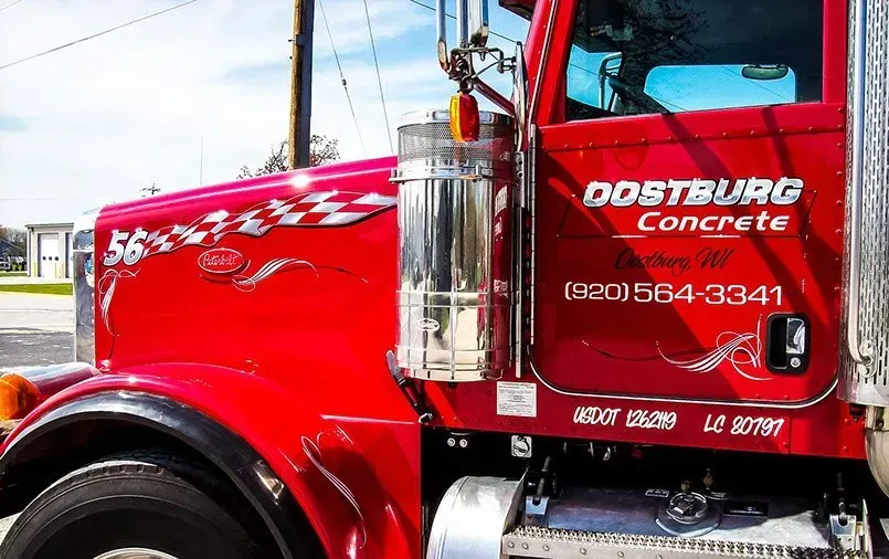 A red truck is parked on the side of the road.