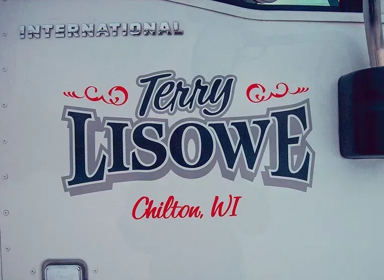 A white truck with the name terry lisowe on it