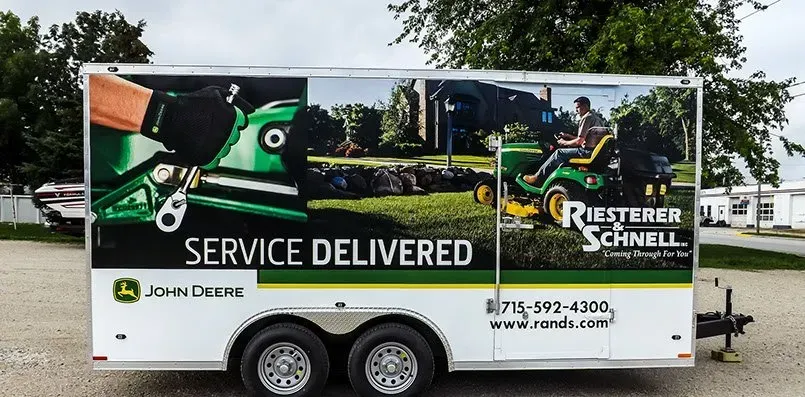 A trailer with a john deere advertisement on it