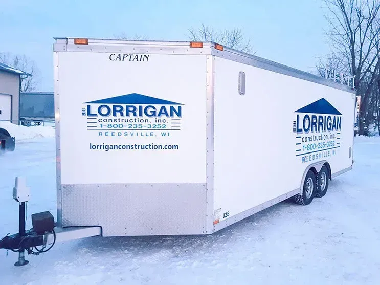 A lorrigan trailer is parked in the snow