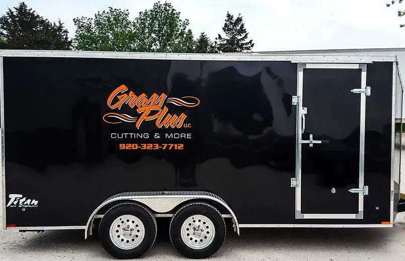 A black trailer that says cutting & more on it