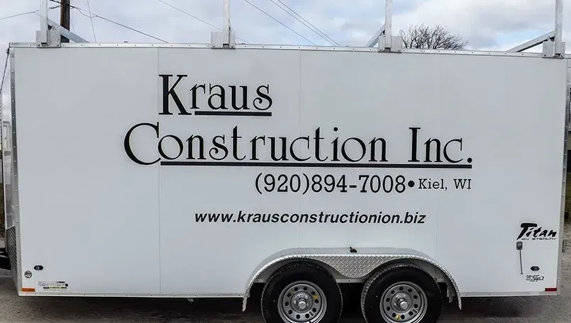 A white trailer with kraus construction inc. written on it