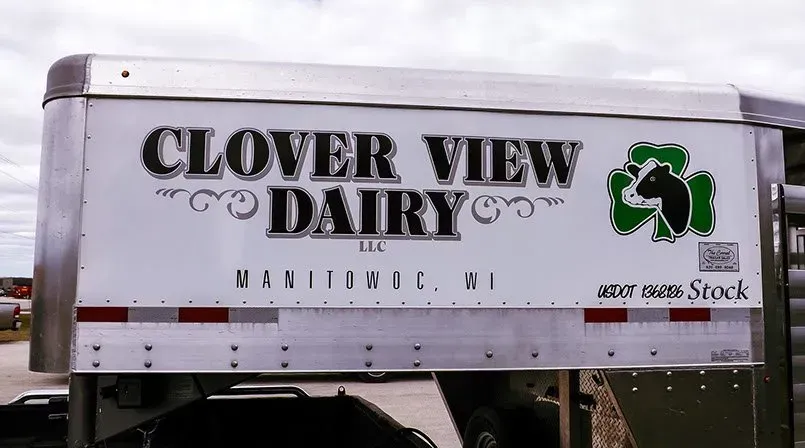A white trailer that says clover view dairy on it