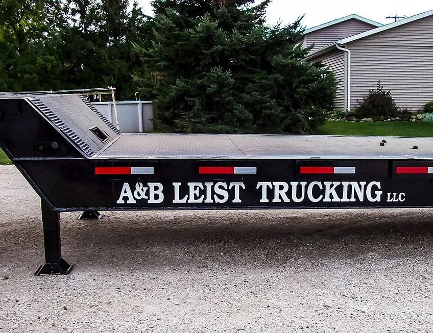 A black trailer that says a & b leist trucking llc