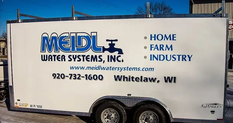 A white trailer that says ' meidl water systems inc ' on it