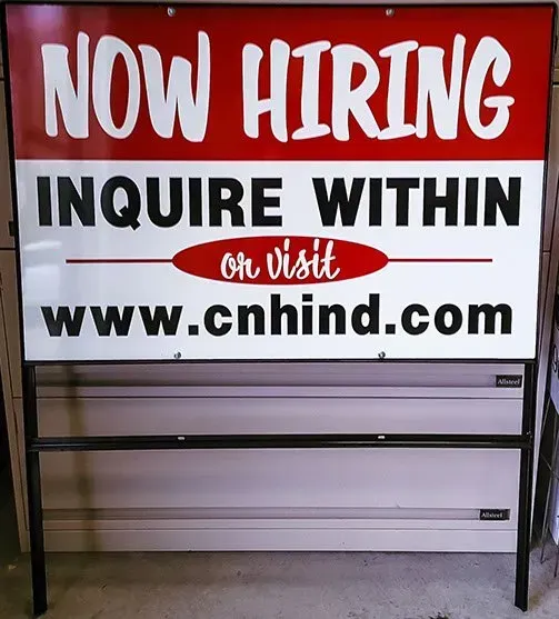 A sign that says now hiring inquire within on visit www.cnhind.com