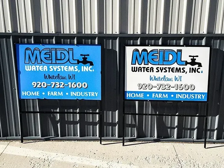 Two blue and white signs for meidl water systems inc.
