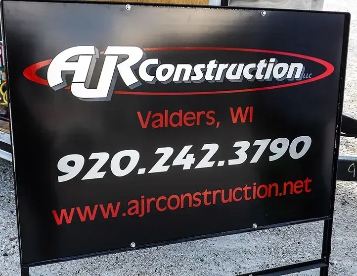 A black sign for air construction in valders wi