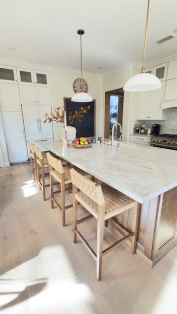 White kitchen cabinets with stainless steel appliances, countertop, and shelving.