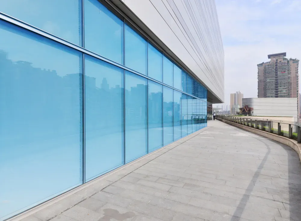 Window Tint Services - A large building with a lot of windows and a concrete walkway.