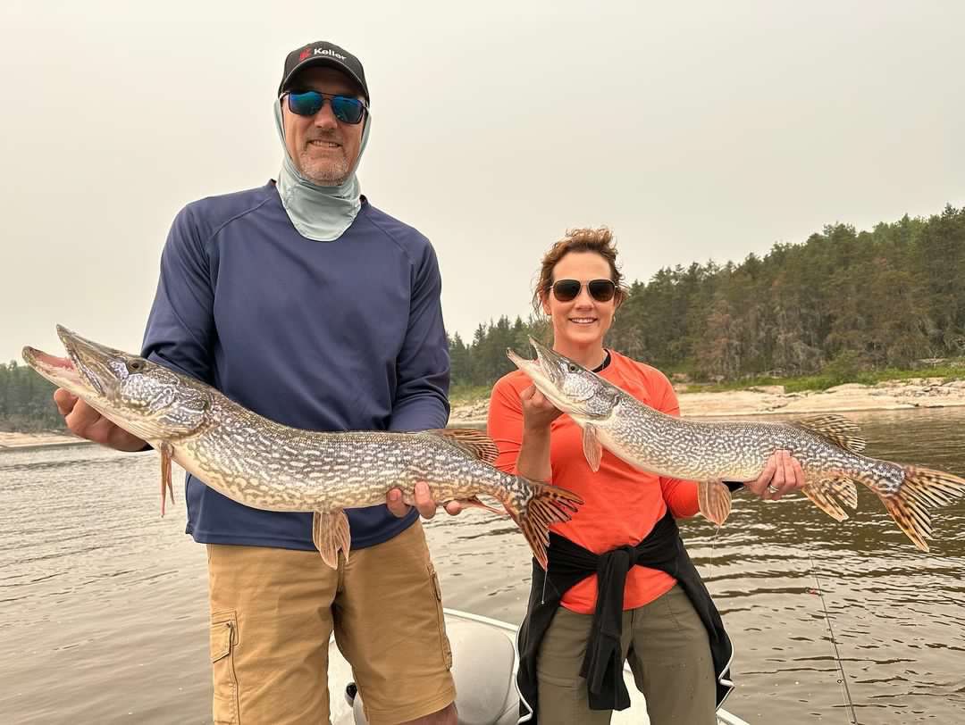 Michelle and Cory with a pair of Northern Pikes.