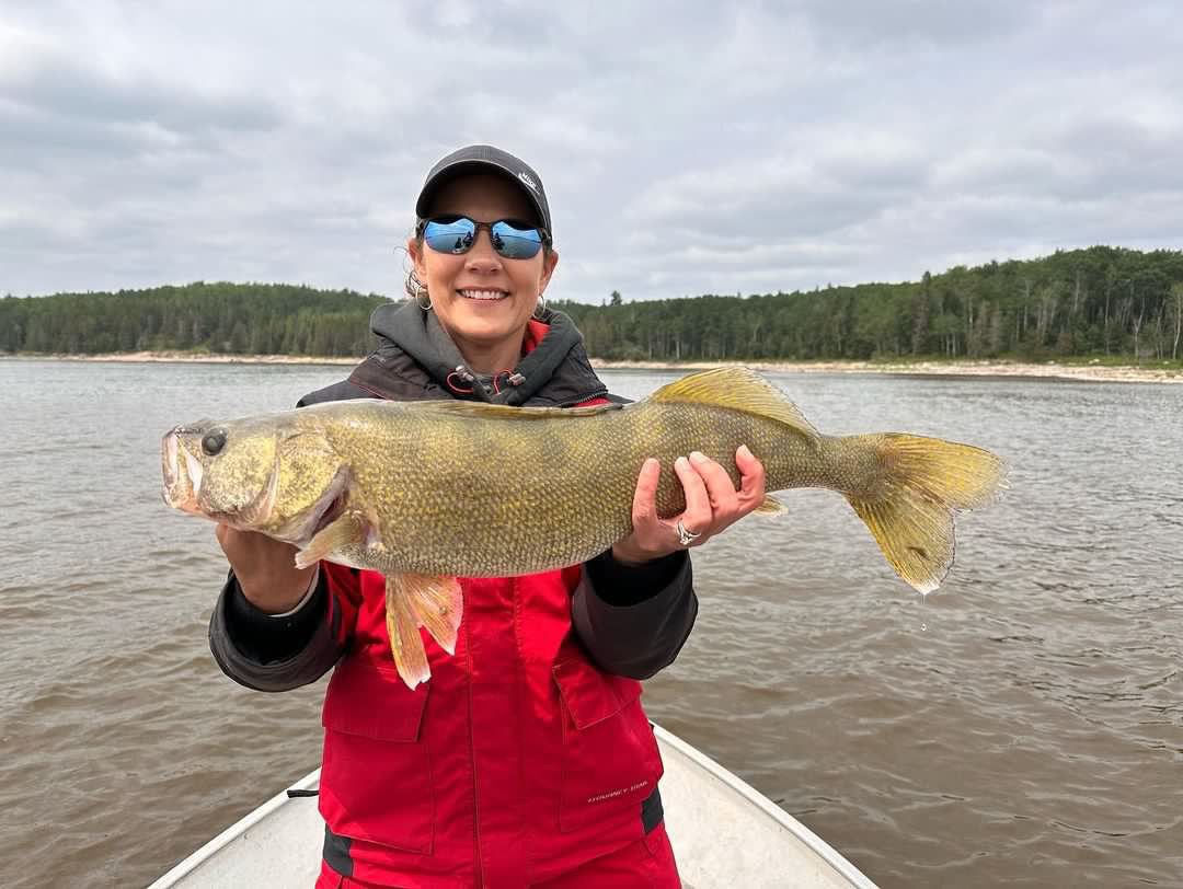 Michelle with a big walleye caught at Oak Lake Lodge, summer 2023.