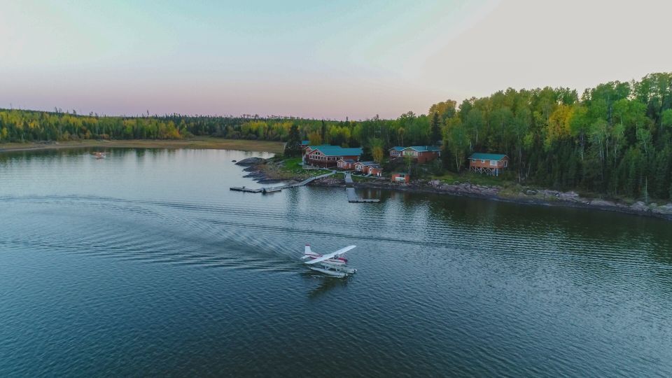An aerial view of a seaplane flying over a lake.