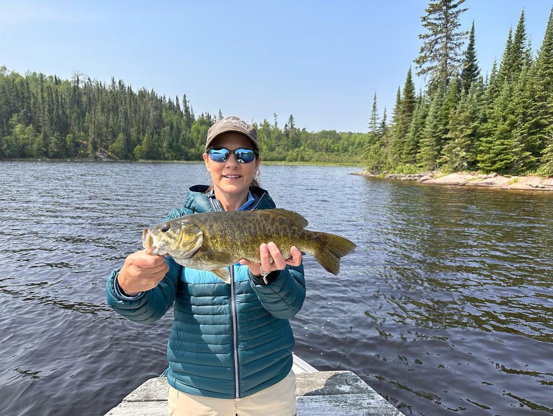 Michelle with a smallmouth bass, summer 2023.