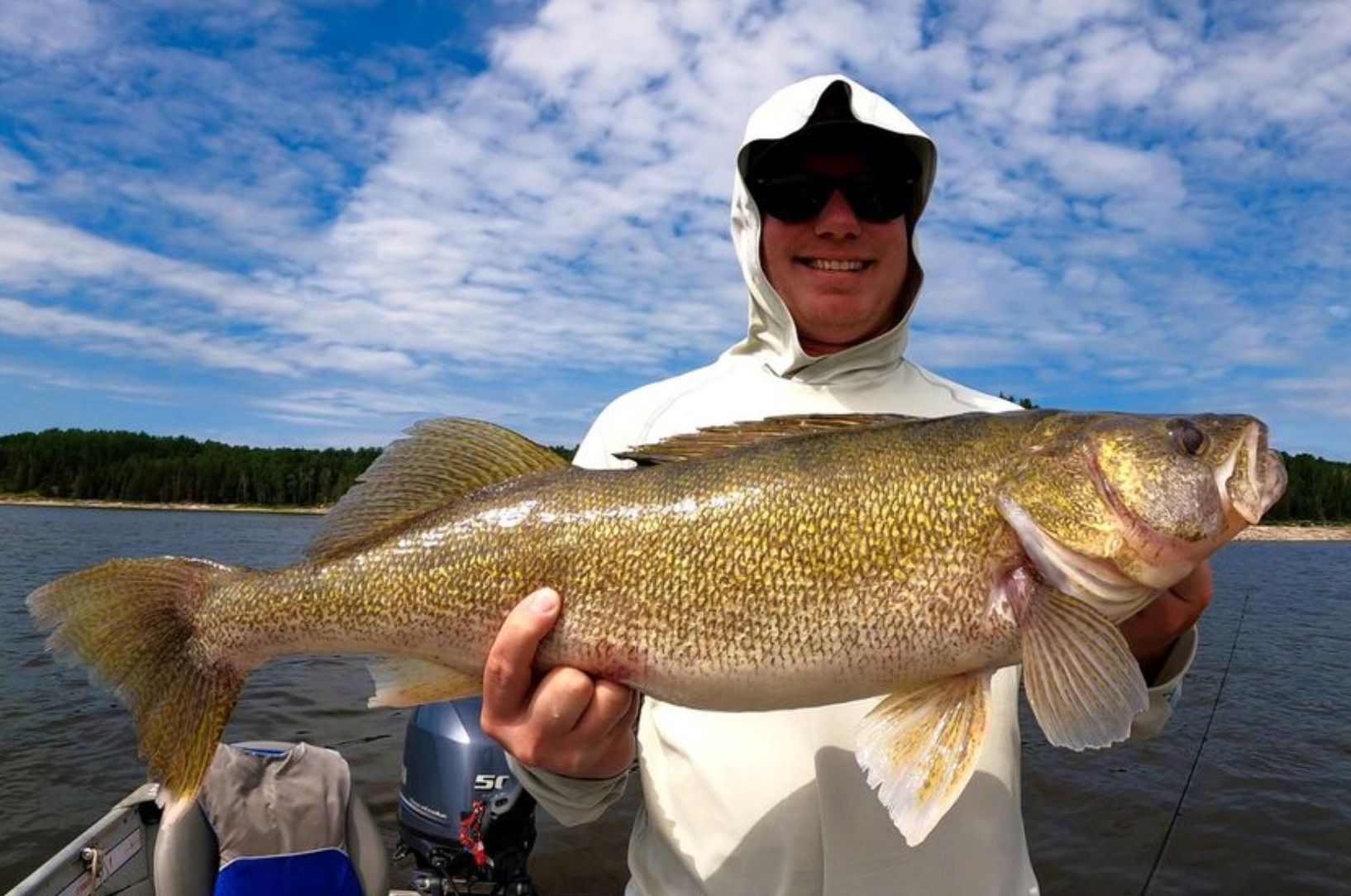 Walleye fish held up before releasing it. Summer 2023.