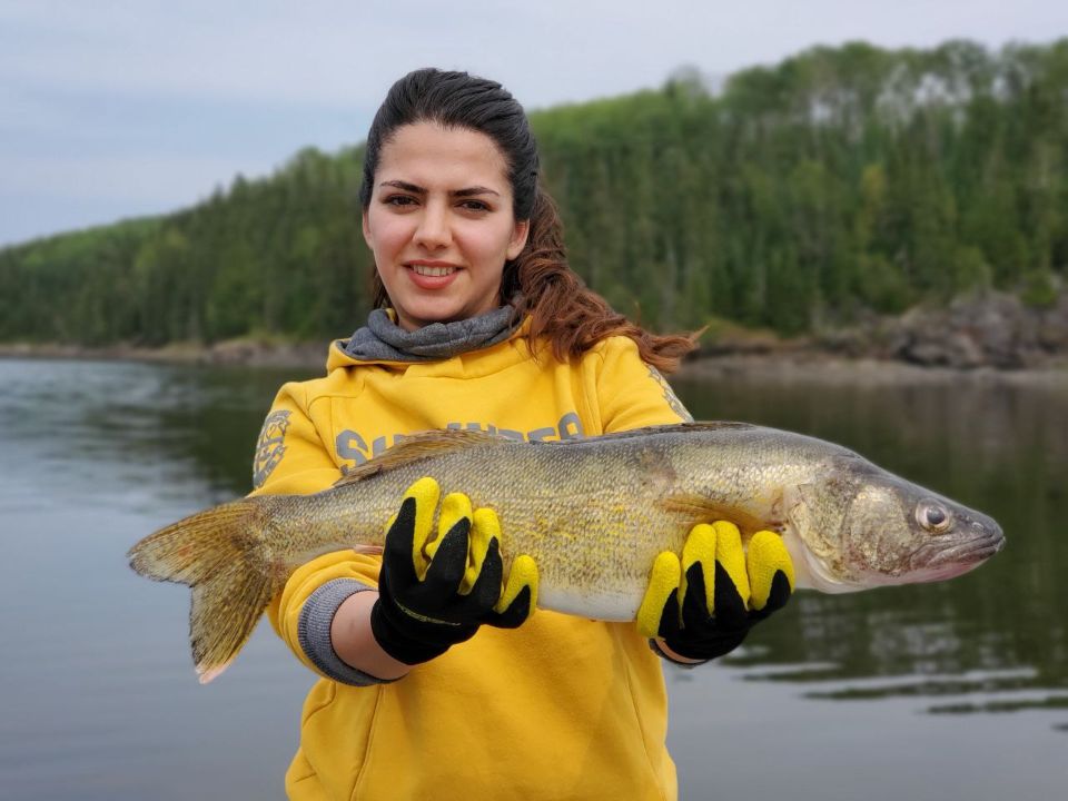 walleye fish held by young woman.