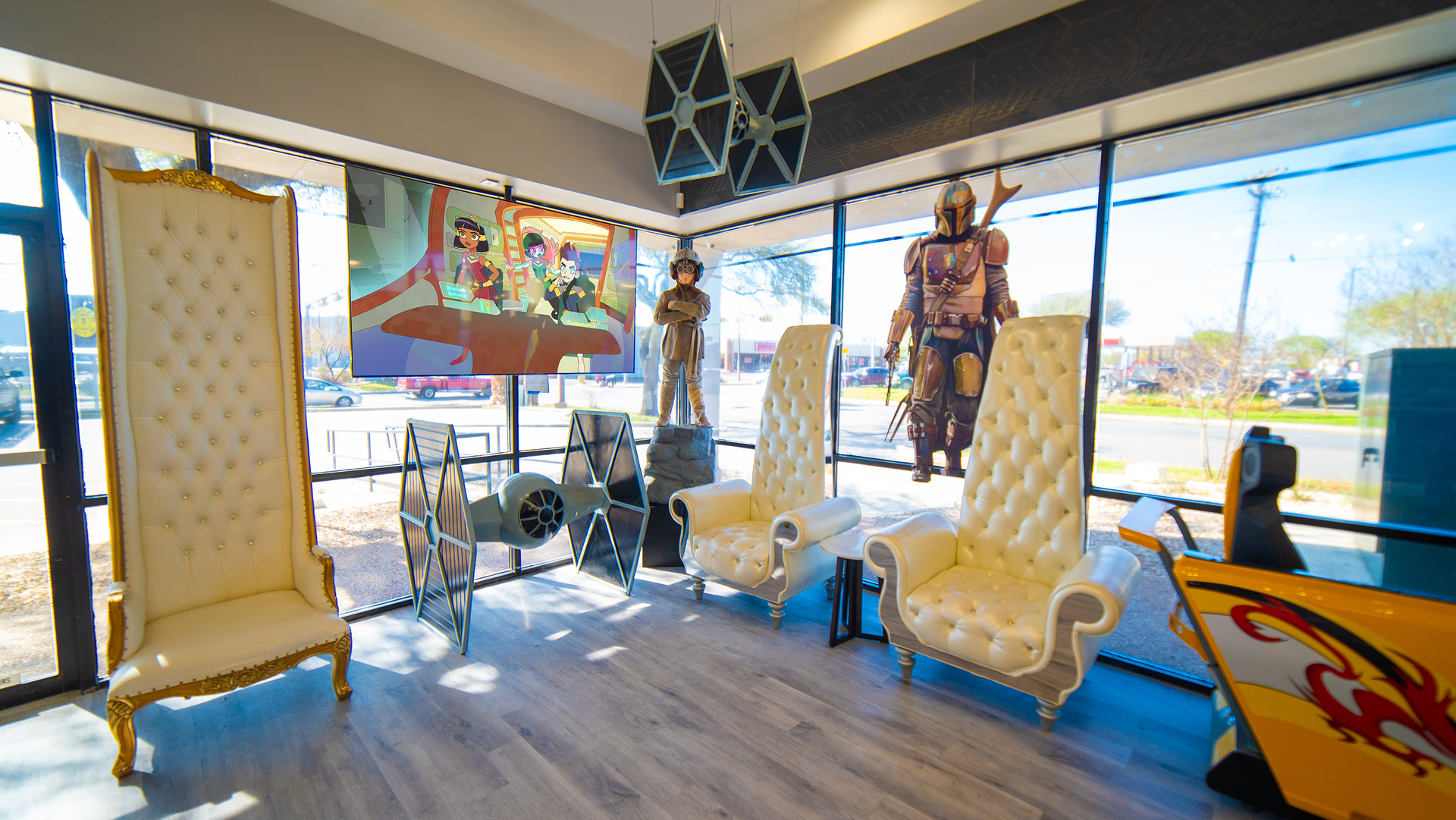 Furniture showroom with ornate chairs, colorful wall art, and large windows