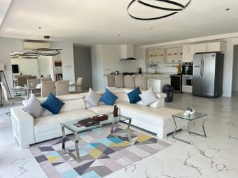 A living room with a couch , table , and television.