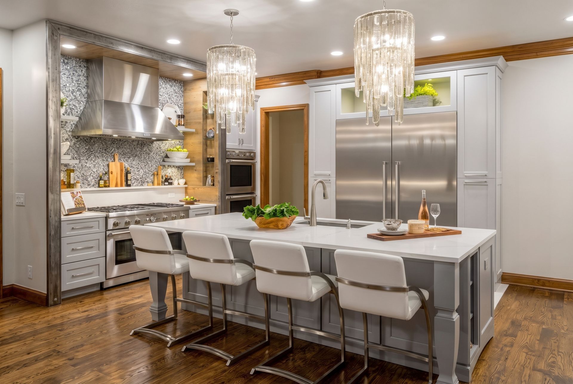Open-concept kitchen with white cabinets, granite counters, stainless fridge, and a blue breakfast bar.