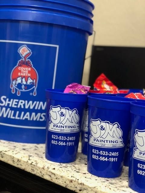 Blue Sherwin-Williams paint bucket and blue cups filled with candy, branded with 