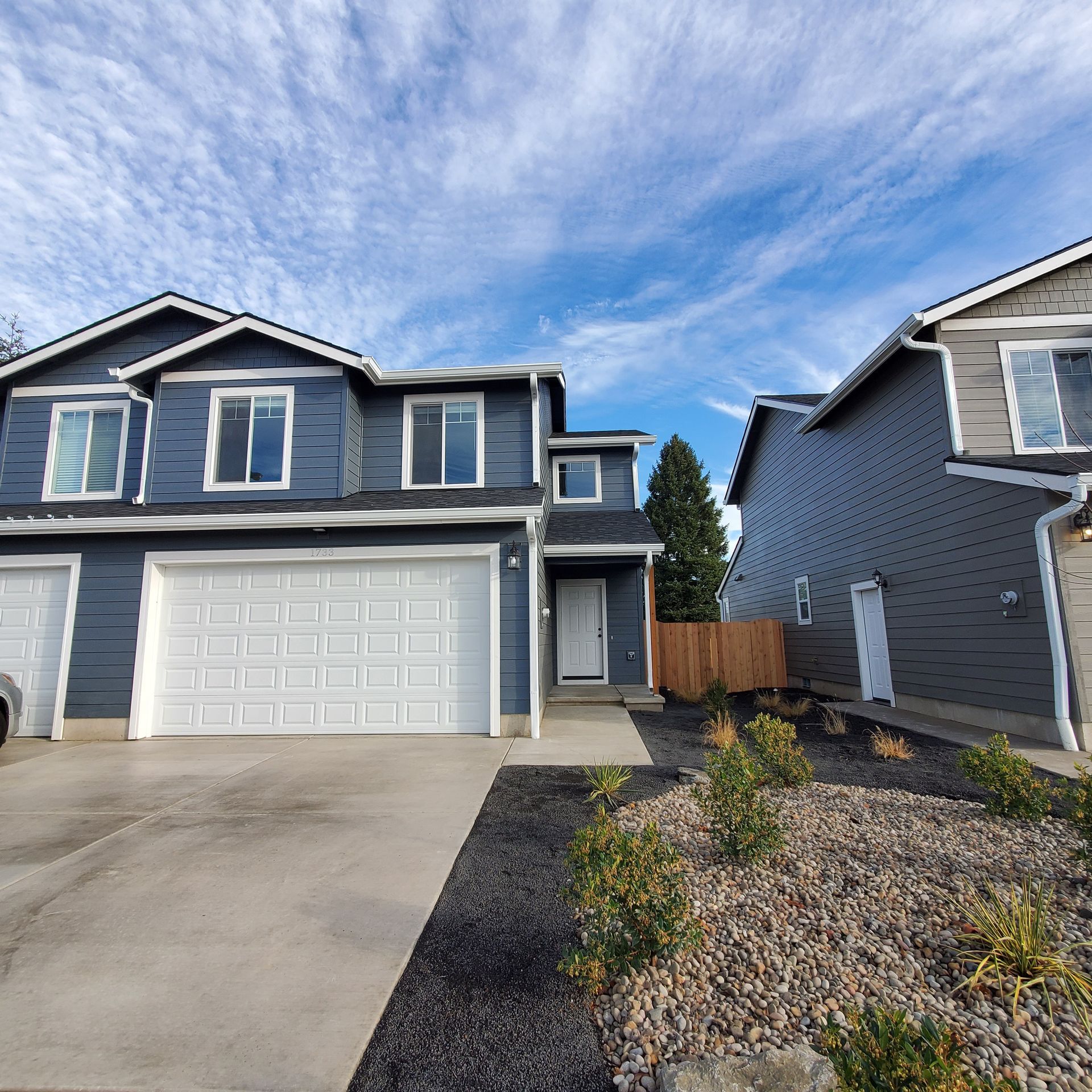 Rye Street Town Homes in Albany, OR. Two Bedroom, Two and 1/2 Bathroom – duplex front, garage doors.