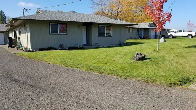 Amanda Lane Duplexes in Millersburg Oregon – duplex home, lawn with tree.