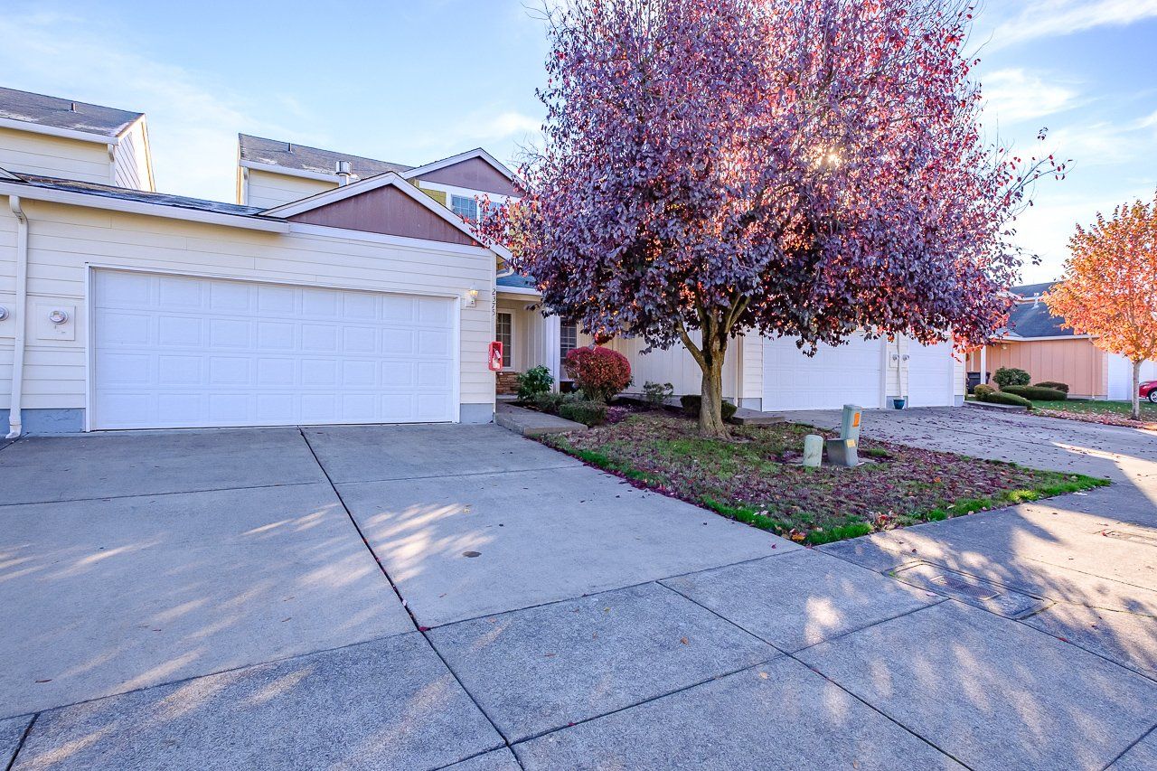 Mt. Vernon Town Homes – in Albany Oregon – white front  home exterior and deciduous tree.
