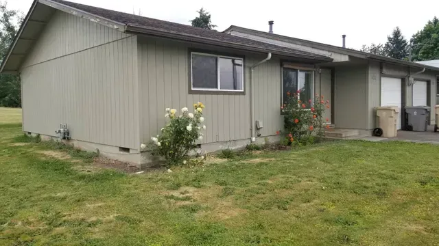 Amanda Lane Duplexes in Millersburg Oregon – gray duplex home and lawn.