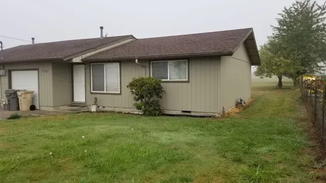 Amanda Lane Duplexes in Millersburg Oregon – green duplex home, garage and lawn.
