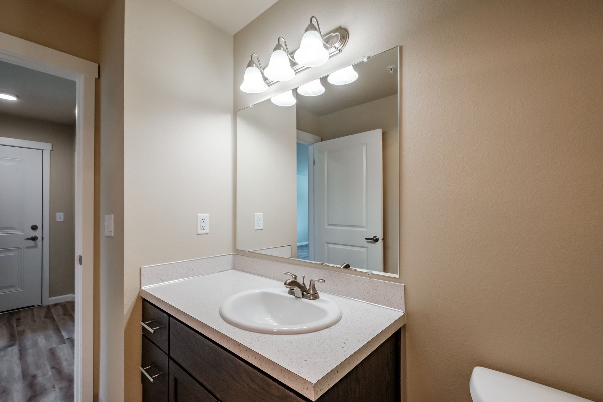 Santiam Gateway Apartments in Sweet Home Oregon, two-bedroom two-bathroom – bathroom sink, mirror and door -2.
