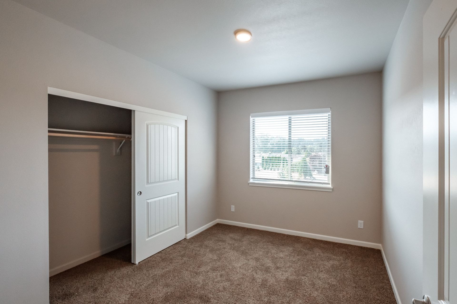 Hickory Hollow Apartments in North Albany OR, three-bedroom two-bathroom –bedroom window and closet -2. 