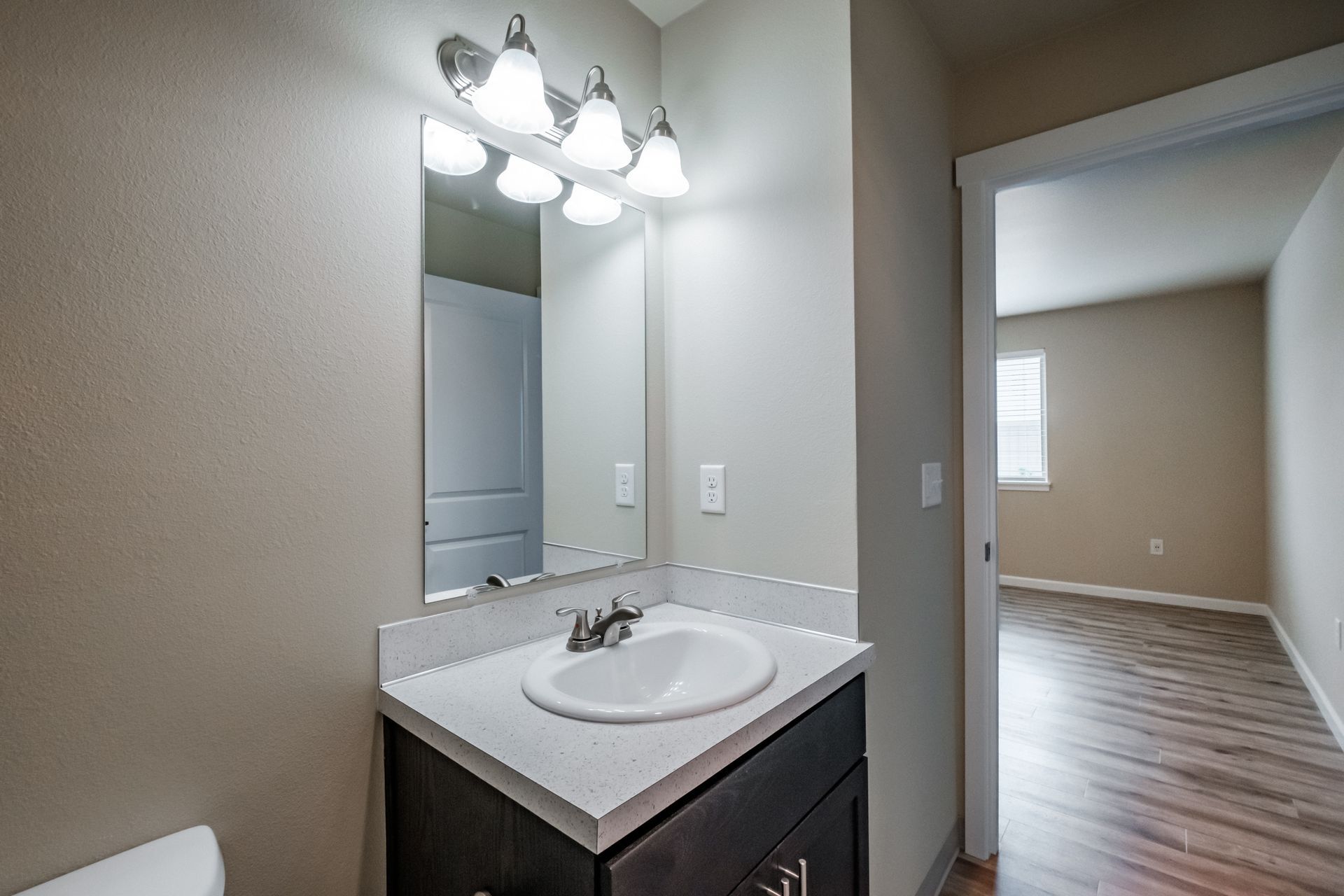 Santiam Gateway Apartments in Sweet Home Oregon, two-bedroom two-bathroom – bathroom sink, mirror and master bedroom -1.