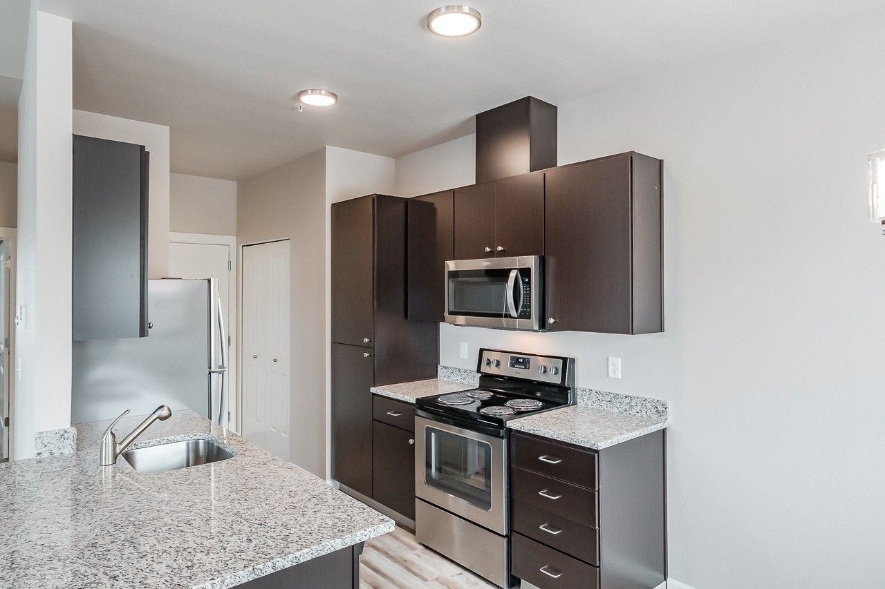 Hickory Hollow Apartments in North Albany OR, one-bedroom one-bathroom – kitchen, stove, microwave, cabinetry.  