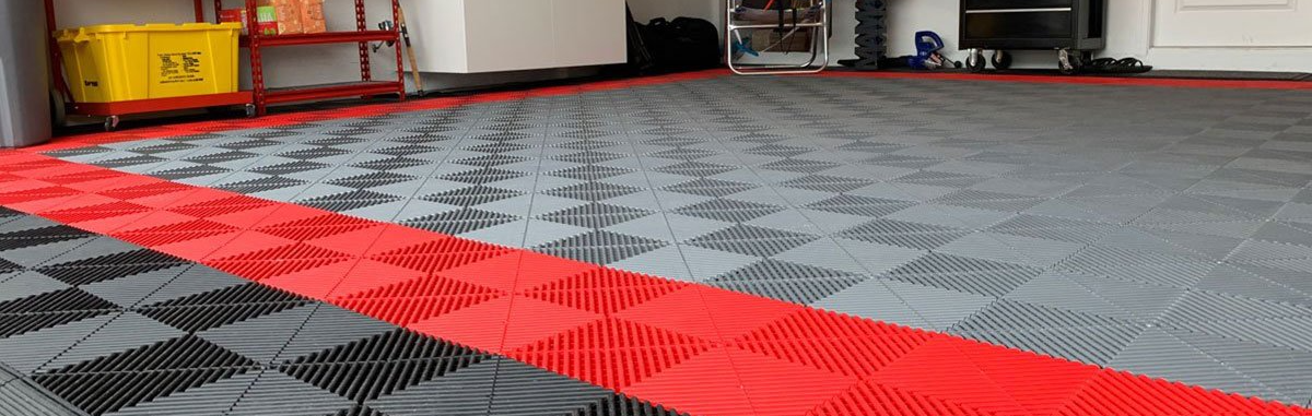 A garage with a checkered floor and a red stripe.