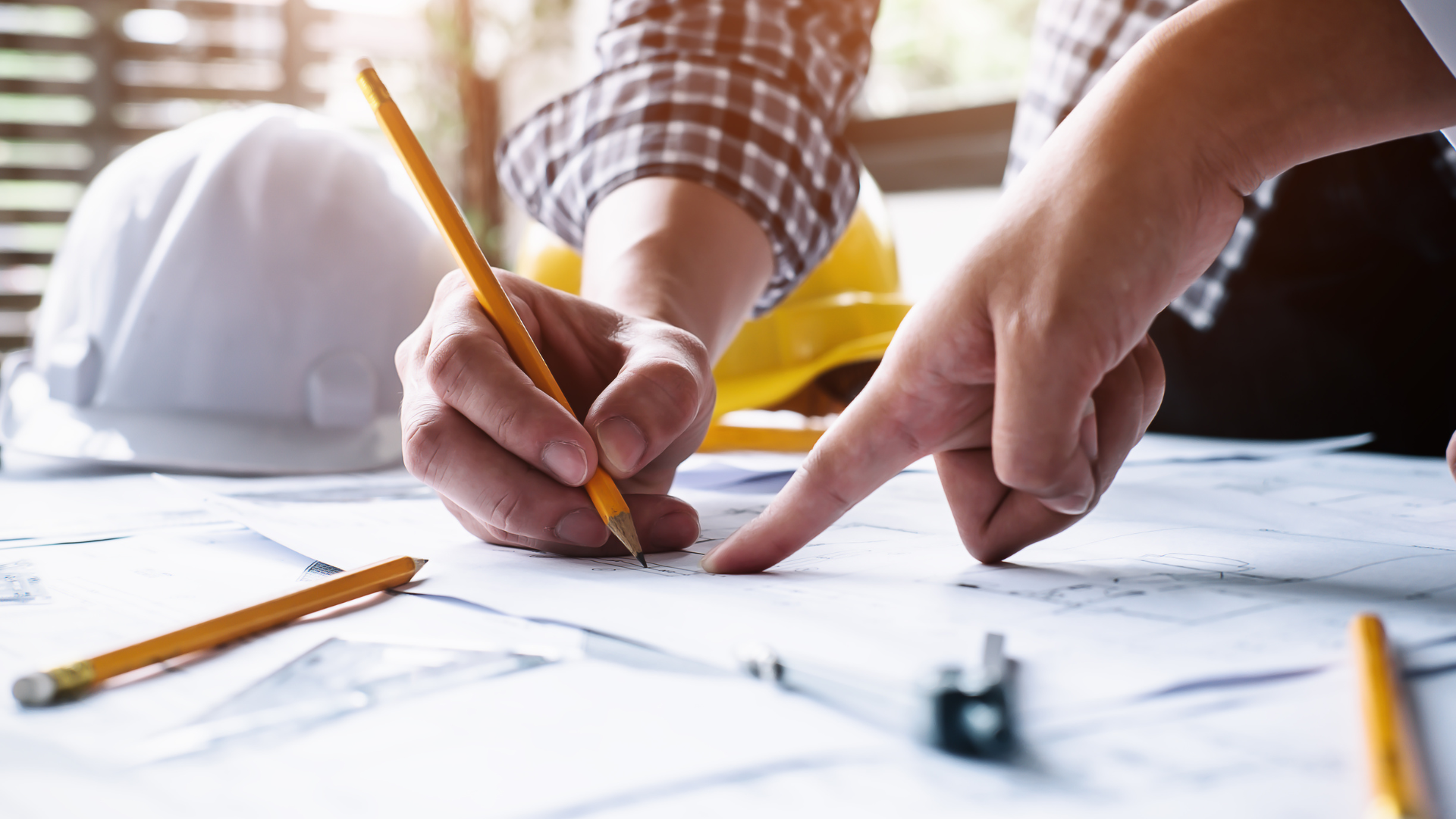 A person is drawing on a piece of paper with a pencil.