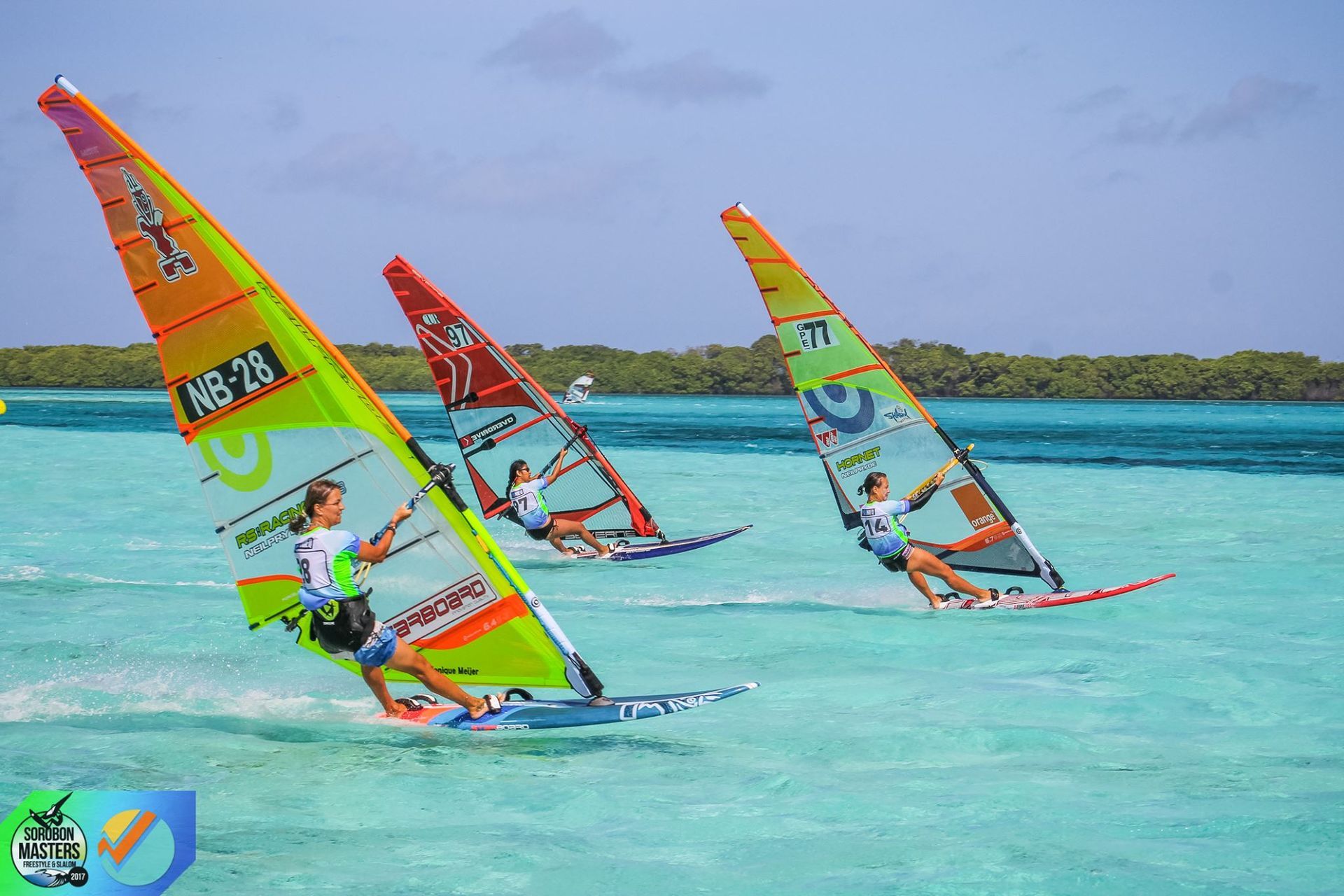 A group of people are windsurfing in the ocean.