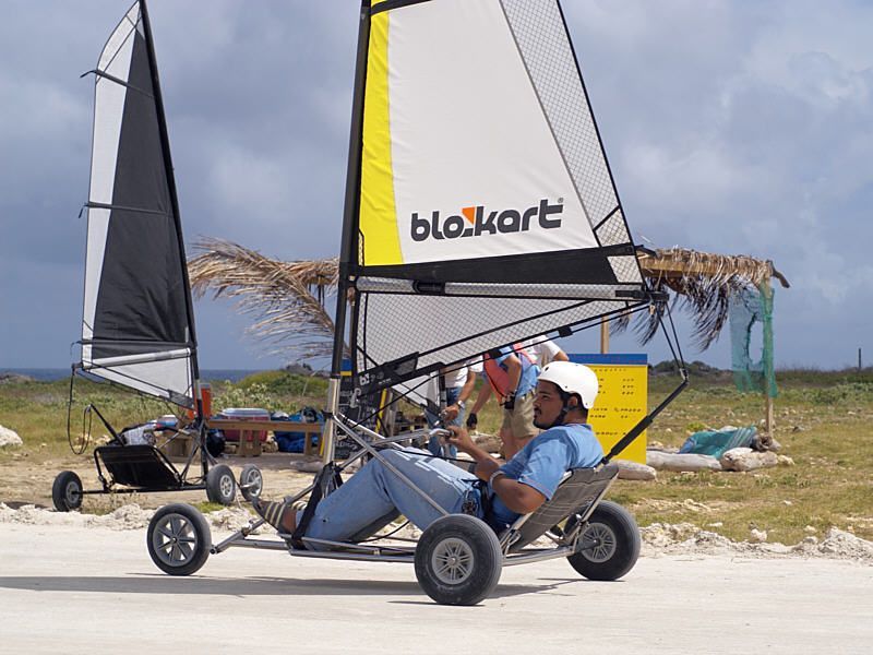 A man is sitting on a blockkart vehicle