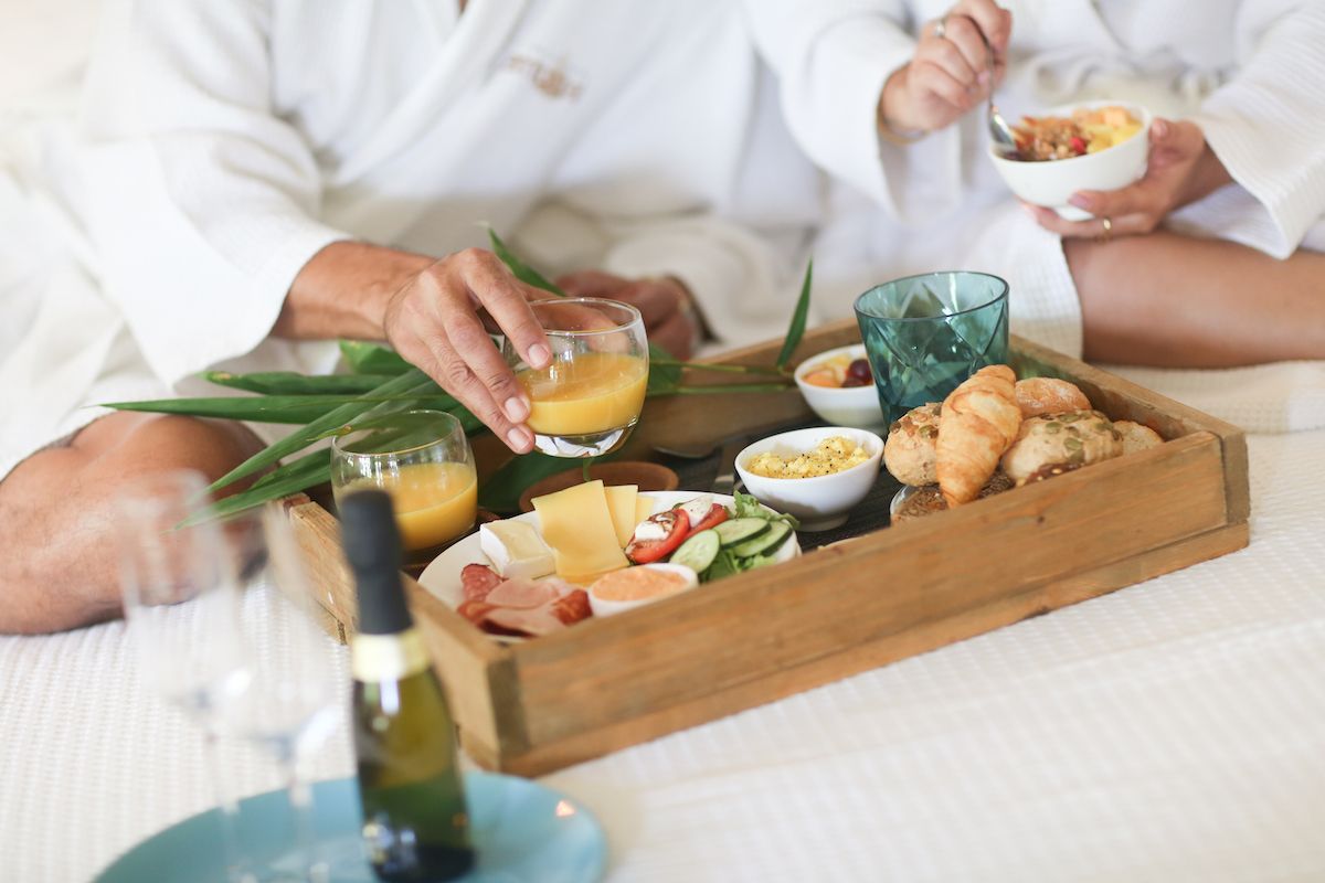 A man and a woman are sitting at a table with a tray of food.