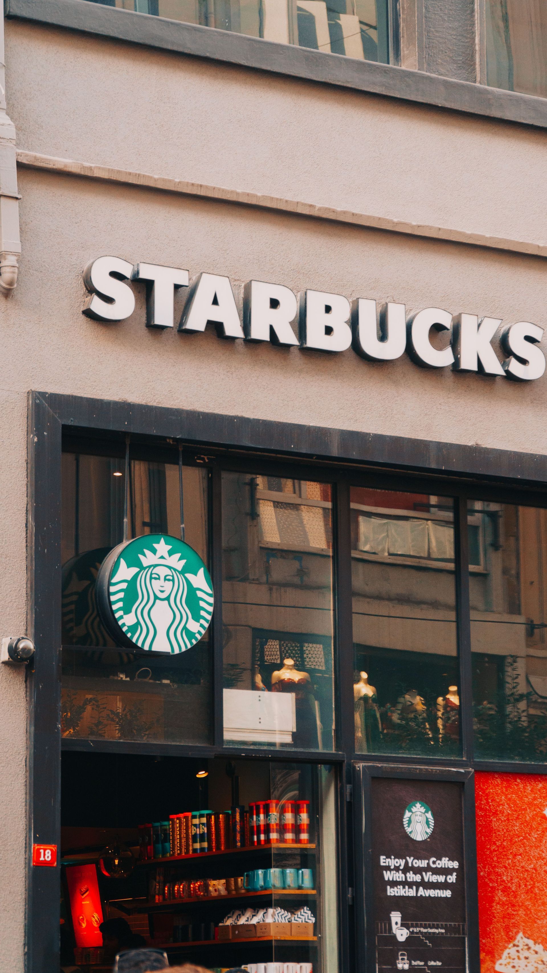 Starbucks storefront with logo and entrance on a city street.