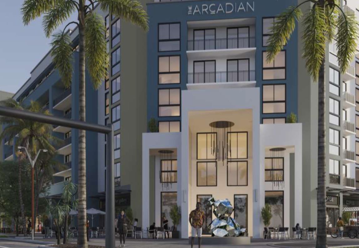 Arcadian hotel exterior with palm trees, blue and white facade at The Arcadian, offers apartments in Fort Lauderdale, FL. 
