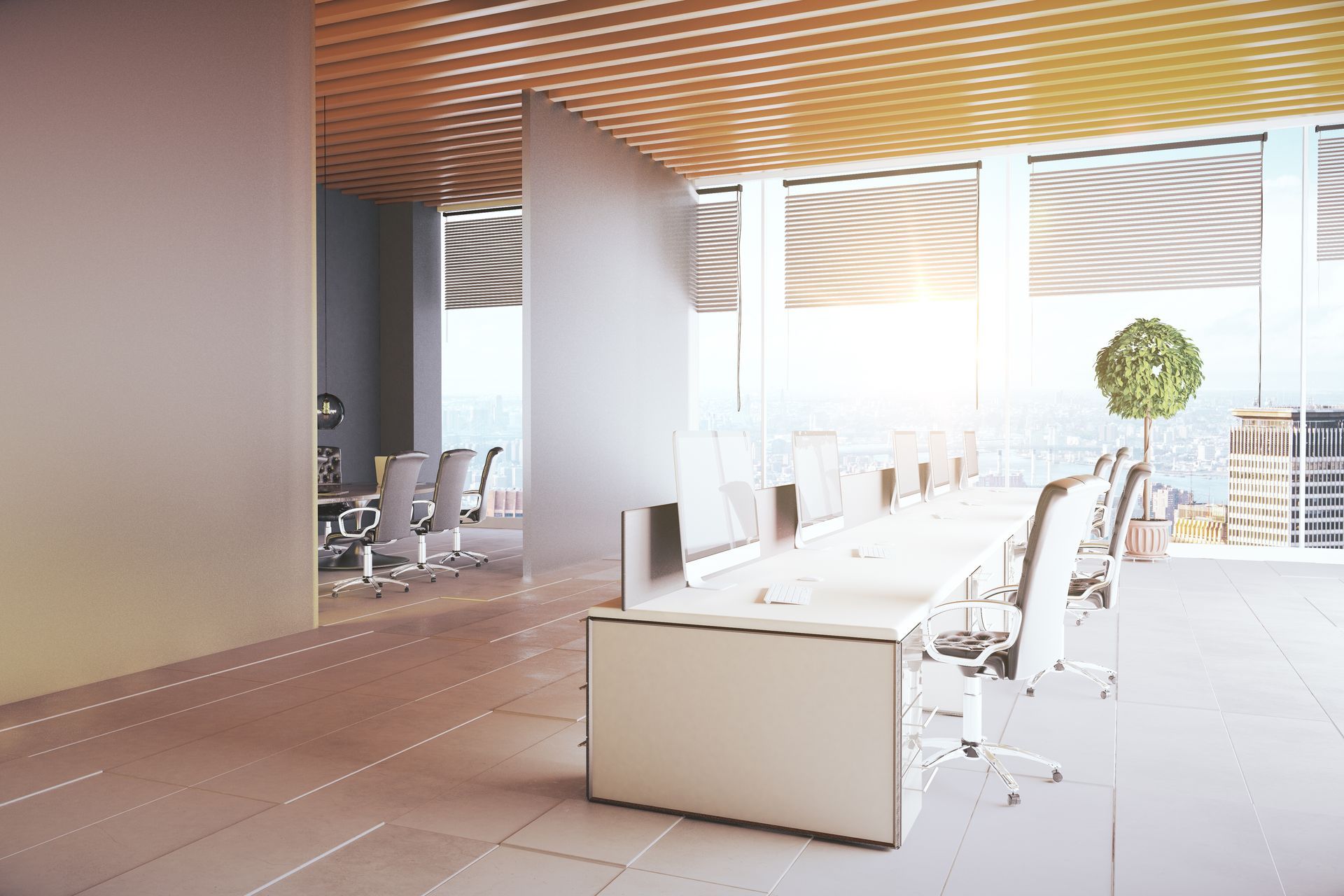 Modern office space with a long desk, white chairs, and large windows.